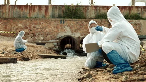 Ecologists sample water contaminated with dangerous, waterhazard toxins in tube Stock Footage 199235553