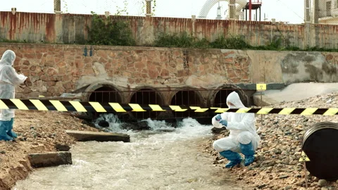 Ecologists sample water contaminated with dangerous, waterhazard toxins in tube Stock Footage 199236305