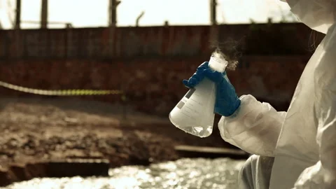 Ecologists sample water contaminated with dangerous, waterhazard toxins in tube Stock Footage 199240717