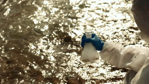 Ecologists sample water contaminated with dangerous, waterhazard toxins in tube Stock Footage 199240746
