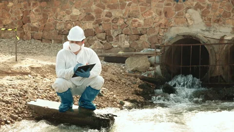 Ecologists sample water contaminated with dangerous, waterhazard toxins in tube Stock Footage 199242327