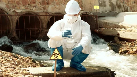 Ecologists sample water contaminated with dangerous, waterhazard toxins in tube Stock Footage 199242700