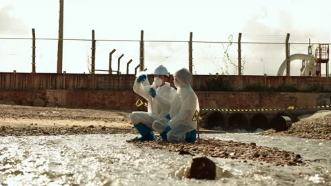 Ecologists sample water contaminated with dangerous, waterhazard toxins in tube Stock Footage 199243061