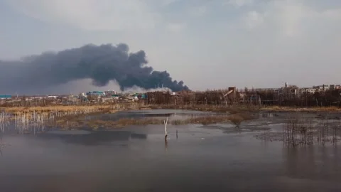 Ecology problems dead lake of smoke and a fire in an industrial area of the city Stock Footage 258406813