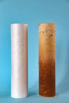 Ecology problems. Two water filters side by side - one dirty the other clean Stock Photos
