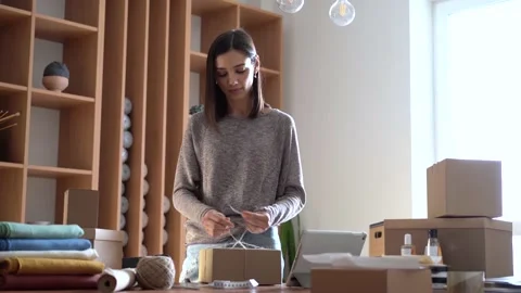 Ecommerce business entrepreneur preparing a package for delivery Stock Footage 149037778