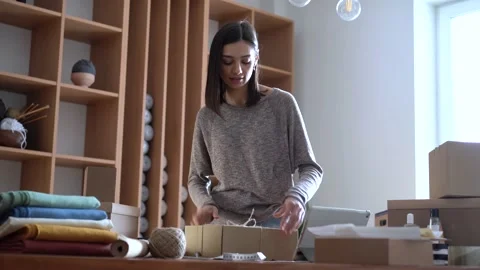 Ecommerce business entrepreneur preparing a package for delivery Stock Footage 149037818