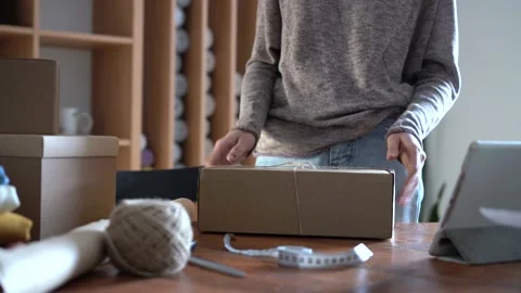 Ecommerce business entrepreneur preparing a package for delivery Stock Footage 149037838