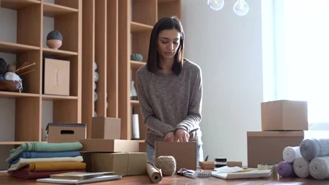 Ecommerce business entrepreneur preparing a package for delivery Stock Footage 149037933