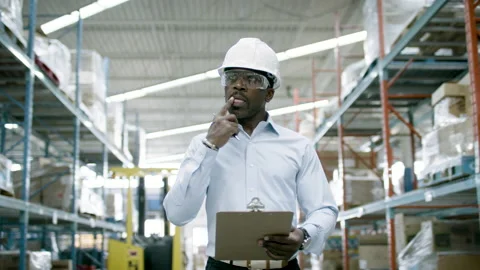 Ecommerce manager looks over inventory and logistics a warehouse facility. Stock Footage 134178118