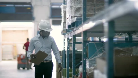 ECommerce warehouse manager inspects inventory at shipping centre. Stock Footage 134177027