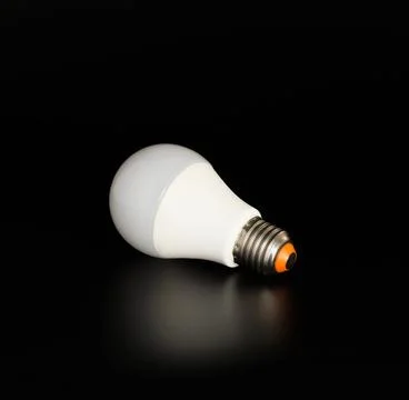 Economical LED light bulb with reflection on a black Stock Photos