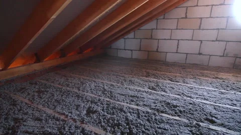 Ecowool insulation is poured in the attic Stock Footage 169317168