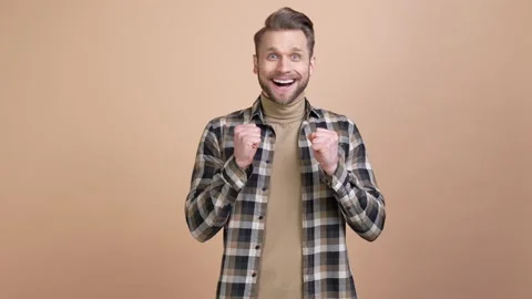 Ecstatic guy look news win discount fist up isolated pastel color background Video stock 176789427
