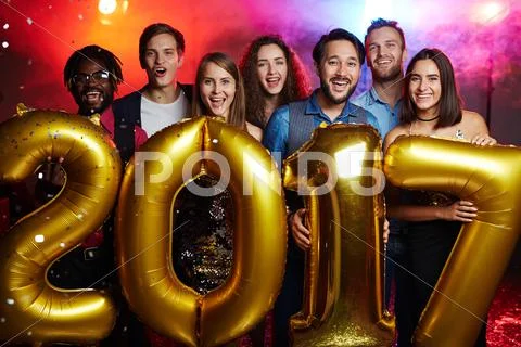 Ecstatic guys and girls holding number of following year Stock Photos