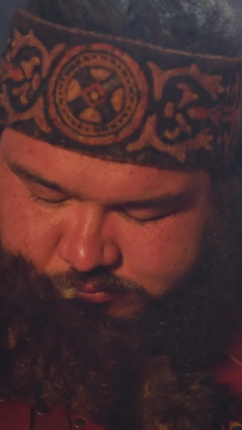 Ecstatic obese man taps shamanic drum doing old ritual Stock Footage 309879614
