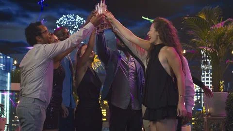 Ecstatic people during New Year Eve exchanging warm best wishes Stock Photos