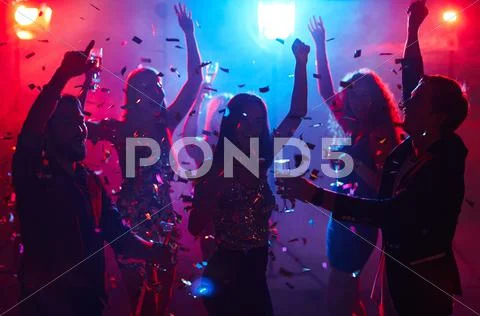 Ecstatic people having party in night club Stock Photos