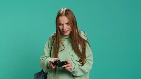 Ecstatic young girl using controller, excited after being victorious Stock Footage 276509983