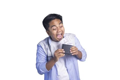 An ecstatic young man with a wide-open mouth looking at a black wallet over.. Stock-Fotos