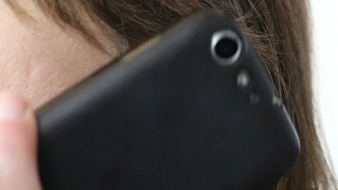 ECU of Cellphone Held to Ear Head Nodding Then Cellular Lowered (angle 2) Stock Footage 87030634