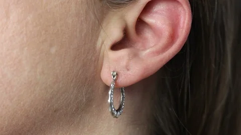 ECU of Hoop Earring Being Removed From Hole in Lobe Stock Footage 87032030