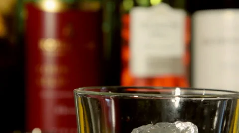 ECU ice being placed in cocktail glass Stock Footage 35193025