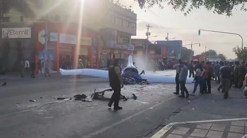 Ecuador: 2 Pilots Dead After Plane Crashes On Busy Street In La Libertad ... Stock Footage 293694066