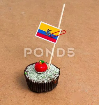 Ecuador flag. Apple Cupcake with red apple shape bonbon on the top Stock Photos
