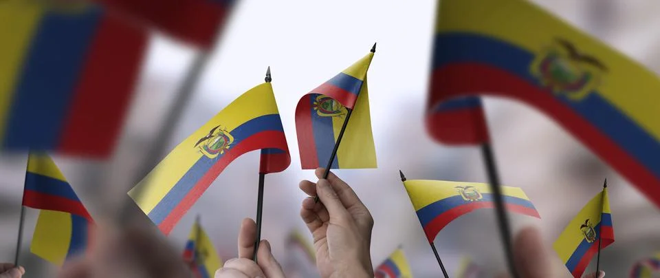 Ecuador flags in their hands on a blurred urban background Stock Photos