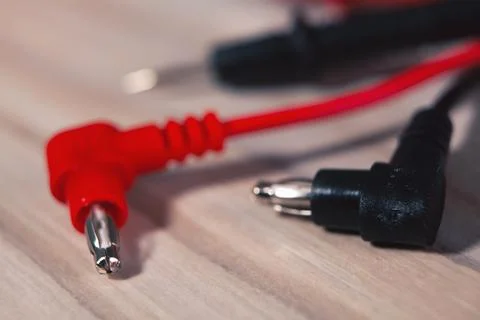 Ed cable with black plug and electrical cord for electrical cables on a woo.. Stock Photos