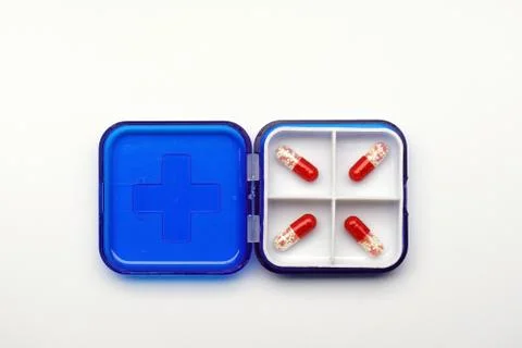 Ed capsules with granules inside in a box, medicine concept Stock Photos