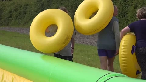 Ed Davey rides down waterslide in rubber ring Stock Footage 276551710