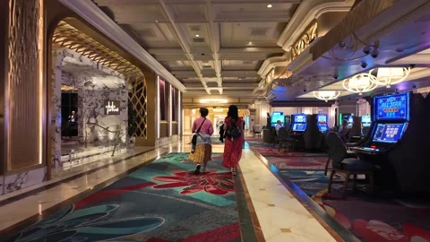 ED: LV, NV, US 8/25/25: Women in Evening Gowns Stroll Past Club and Casino in Stock Footage 319029654