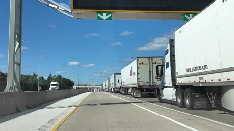 ED: Sarnia, ON, CA 10/01/2024: Driving by Blue Water Bridge Border Crossing Sign Stock Footage 342670077
