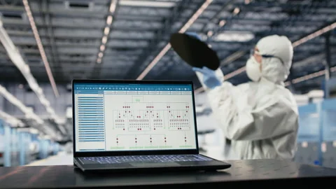 EDA software on laptop used by technician in semiconductor factory Stock Footage 333391747