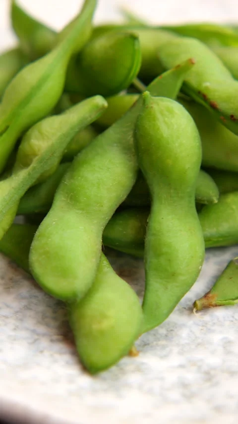 Edamame served on a plate in a kitchen setting Stock Footage 340063277