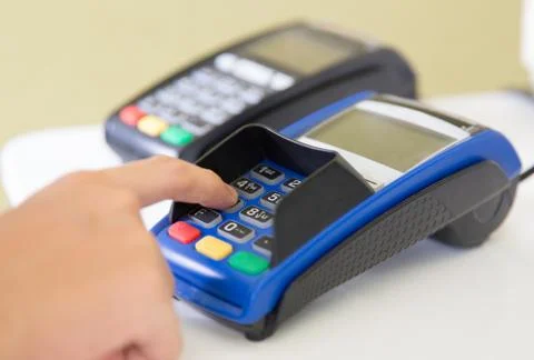 EDC ( electronic Data Capture) machine hand pressing password on it 스톡 사진