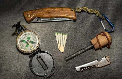 EDC. Wearable survival kit. Folding knife, compass and hunting matches Stock Photos