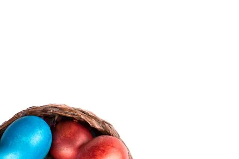 The edge of the basket with Easter eggs with place for text. Stock Photos