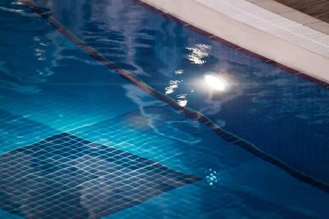 Edge of blue lightened swimming pool Stock Photos