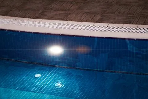 Edge of blue swimming pool Stock Photos