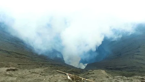 On the edge of the crater from the Bromo volcano on Java Indonesia Stock Footage 87306853