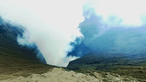 On the edge from the crater of the Bromo volcano on Java Indonesia Stock Footage 87306977