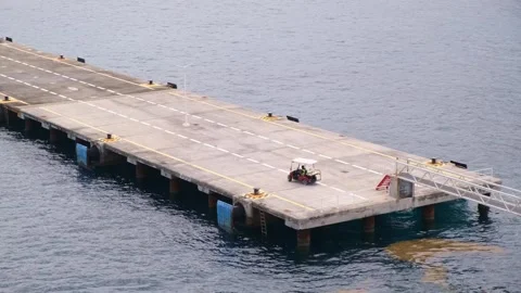 Edge of empty pier on which electric docker car moves to berth of cruise liner Stock-Footage 274438994