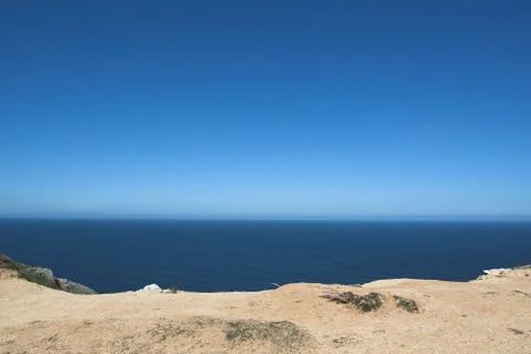 Edge of Espichel Cape facing the Atlantic Ocean horizon Stock Photos