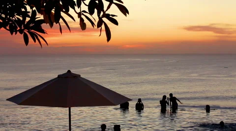 Edge of infinity swimming pool overlooking ocean at sunset Stock Footage 61793645
