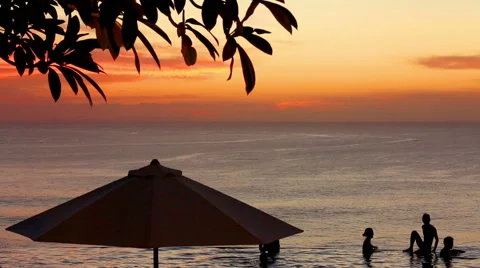 Edge of infinity swimming pool overlooking ocean at sunset Stock Footage 61793902