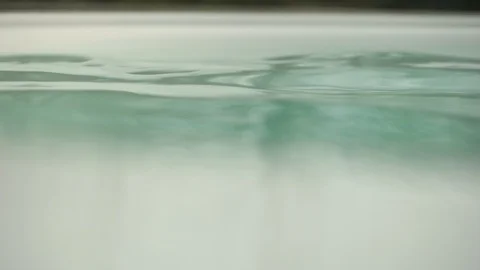 Edge of jacuzzi pool with water waves, fading shot into the trees Stock Footage 94184071