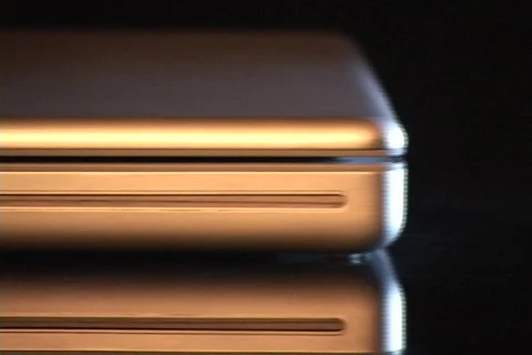 The edge of a laptop computer reflects silver light. Video stock 438147